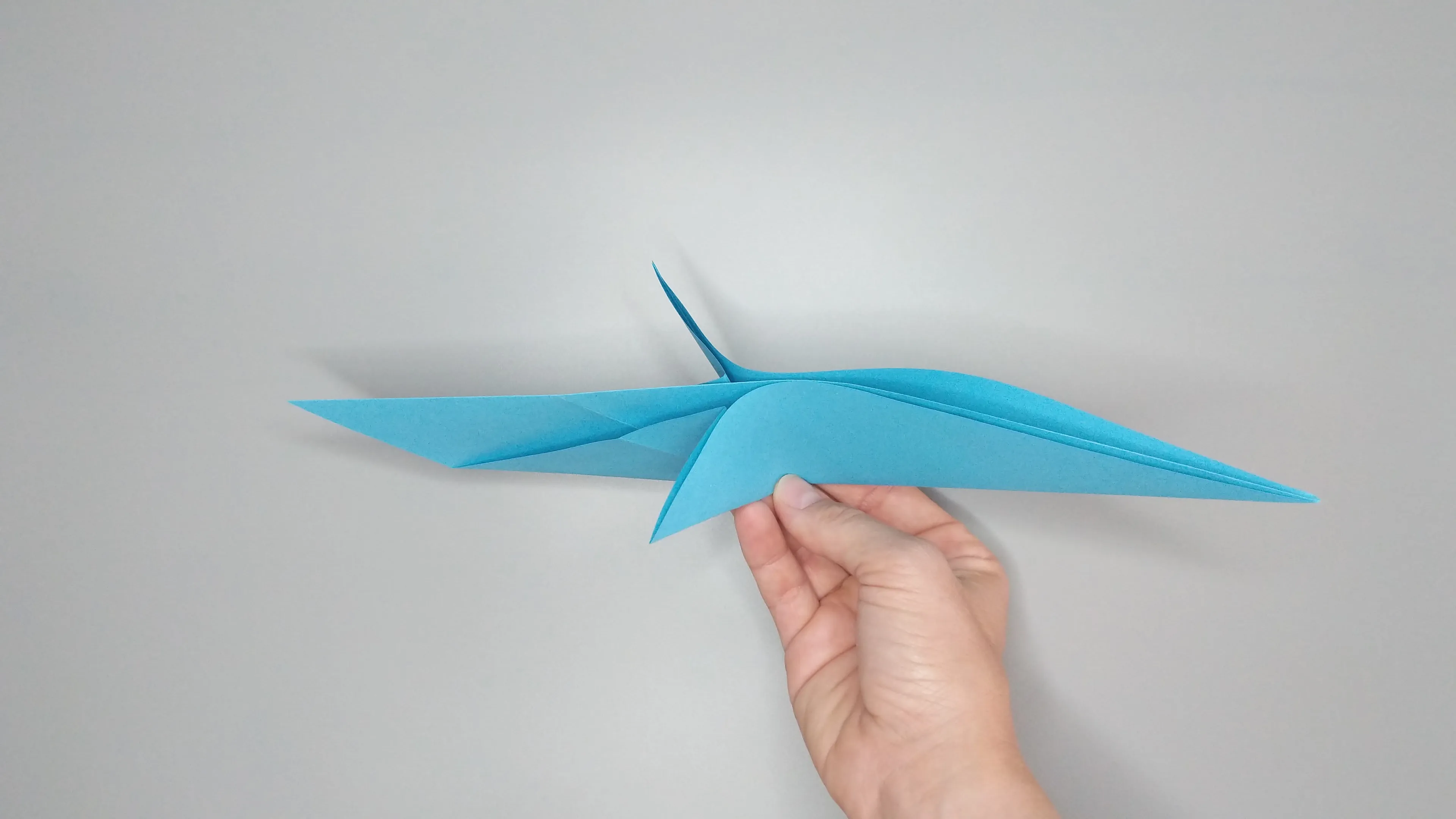 Instructions with photos for folding an origami swan. Step number 14