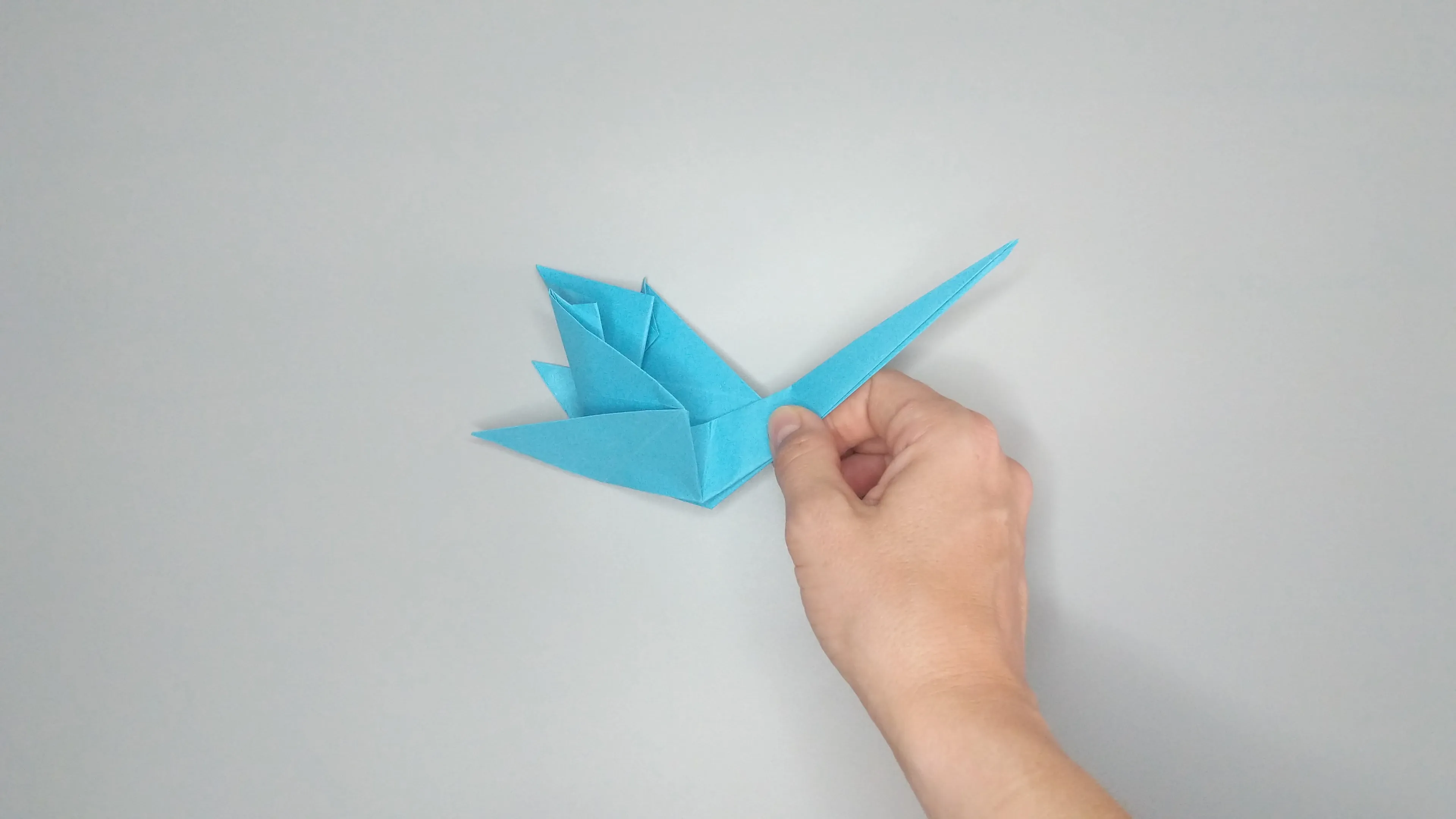 Instructions with photos for folding an origami swan. Step number 33