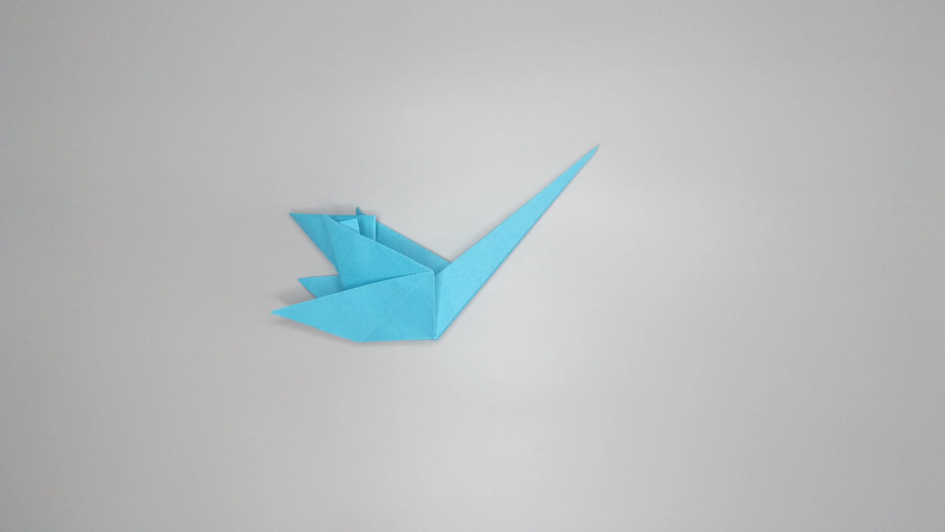 Instructions with photos for folding an origami swan. Step number 34